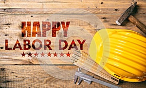 Happy Labor Day text and construction tools on wood. USA holiday celebration