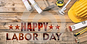 Happy Labor Day text and construction tools on wood. USA holiday celebration