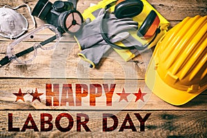 Happy Labor Day text and construction tools on wood. USA holiday celebration