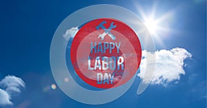 Happy labor day text over red circular banner against clouds in blue sky