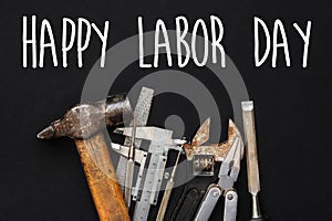 Happy labor day text sign. Working tools on black background. se