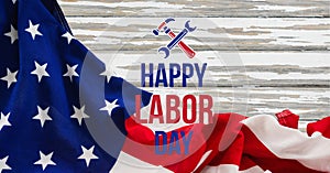 Happy labor day text and tool icons against american flag on wooden background