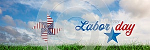 Happy labor day text and USA wind catcher in front of grass and sky