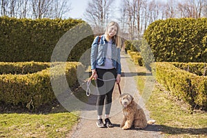 Happy Labradoodle Dog and woman outside at the park