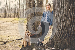 Happy Labradoodle Dog and woman outside at the park