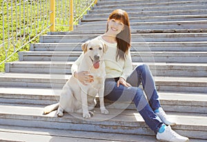 Happy labrador retriever dog and owner woman together