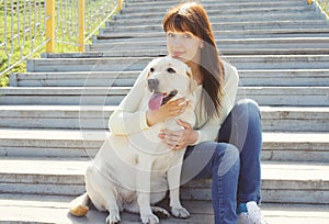 Happy labrador retriever dog and owner woman together