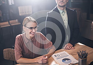 Happy lady sitting at desk