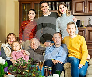 Happy large family gathered in parental home