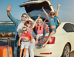 Happy large family  in summer auto journey travel by car on beach