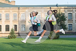 Happy last day of school. School children in high jump. School holidays. Energetic children in midair outdoors. Children