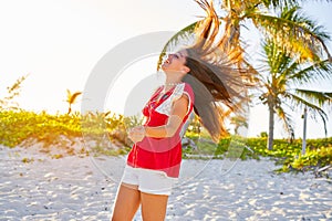 Happy latin beautiful girl in caribbean beach