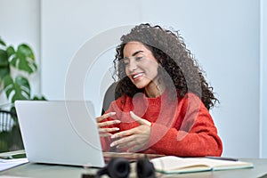 Happy latin business woman having video call hybrid meeting in office.