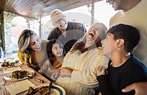 Happy Latin family having fun lunching together at home