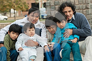 Latin family sitting in the street