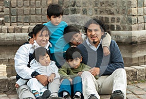 Latin family sitting in the street