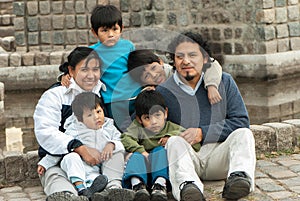 Latin family sitting in the street