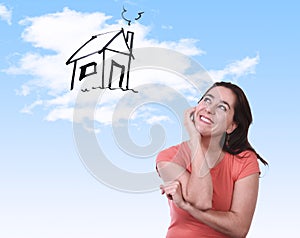 Happy Latin woman dreaming of new house real estate concept