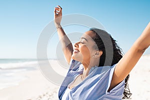 Happy latin woman enjoy the sun at beach