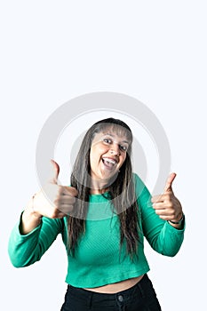 Happy Latin young woman showing thumbs up sign with both hands on white background