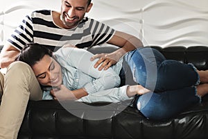 Happy Latino Couple Having Fun And Laughing On Sofa