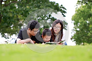 Happy latino family reading book