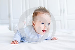 Happy laughing baby enjoying her tummy time