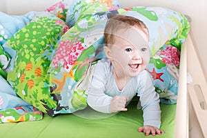 Happy laughing baby playing peek-a-boo