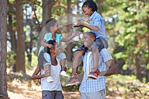 Happy, laughing or black family hiking in forest to relax or bond on holiday together in nature. Funny children siblings