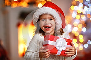 Happy laughing child girl with christmas present