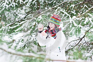 Happy laughing child playing snow ball fight