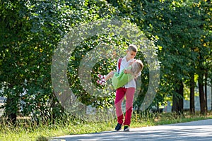 Happy laughing children playing and having fun in the park. Outdoors portrait on a sunny summer day. Older brother