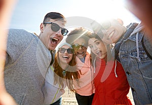 Happy laughing friends taking selfie