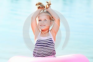 Happy laughing girl holds pigtails