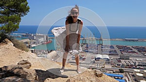 Happy laughing girl playing with her flying dress like Marilyn Monroe