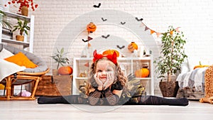 Happy laughing girl in witch costume for Halloween