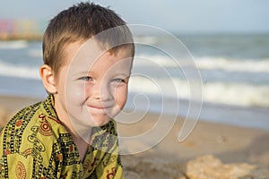 Happy laughing kid on sand beach