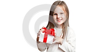 Happy laughing little girl, preschooler holding birthday present, gift box with red bow. excited and surprised. a forced,