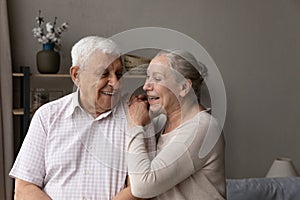 Happy laughing older married couple talking, laughing