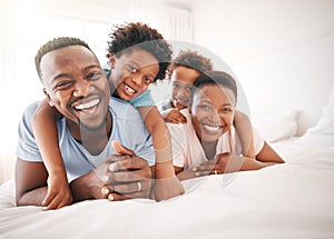 Happy, laughing and portrait of a black family on a bed for playing, quality time and comfort. Bonding, love and African