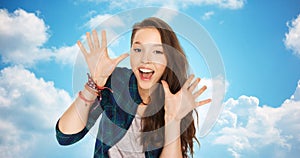 Happy laughing pretty teenage girl showing hands
