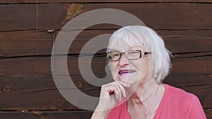 Happy and laughing senior woman with gray hair, portrait closeup