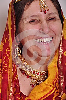Happy laughing senior woman in traditional Indian clothing and jeweleries