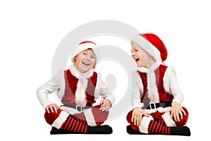 Happy laughing toddler boys in Christmas santa clothes. Isolated white background.