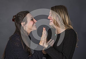 Happy laughing women palms together