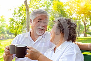 Happy life and long lived concept. Older couple is clinking cup of coffee and enjoying the drink in the morning. Handsome