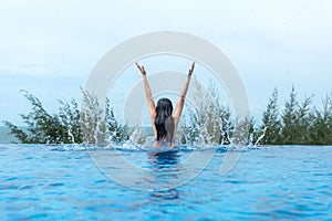 Happy lifestyle women relax and enjoy in the pool near the beach. Women together on summer and vacations travel to luxury resort.