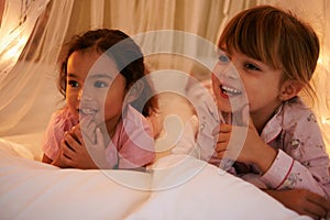 Happy, lights and children at night in bedroom for resting, relaxing and dreaming in home. Sleepover, sibling and young