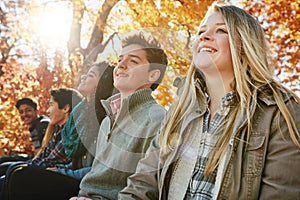 Happy, line and friends outdoor in park for relaxing day on summer vacation of semester break, together and bonding photo