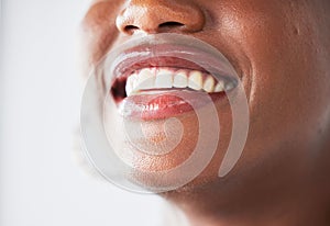 Happy, lips and beauty with a woman closeup in studio on a gray background for makeup or cosmetics. Smile, mouth and